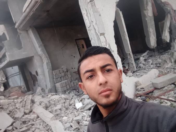 Muhammad in the ruins of his family's bombed home